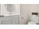 Well-lit powder room featuring a vanity with a round mirror and a toilet at 2120 Turtle Point Rd, Charlotte, NC 28262