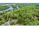 Scenic aerial view of a wooded community with winding roads and waterways, showcasing the area's peaceful setting at 2144 Newhart Rd, Charlotte, NC 28214