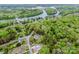 Expansive aerial view of a residential area near a beautiful lake, highlighting the landscape's proximity to water at 2144 Newhart Rd, Charlotte, NC 28214