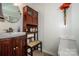 Charming bathroom boasts vanity sink, medicine cabinet, toilet, and decorative flower arrangement at 2144 Newhart Rd, Charlotte, NC 28214