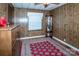 Wood paneled bedroom with a decorative display cabinet and area rug at 2144 Newhart Rd, Charlotte, NC 28214