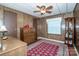 Cozy bedroom featuring wood paneling, a dresser, and a decorative curio cabinet at 2144 Newhart Rd, Charlotte, NC 28214
