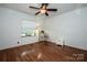 Bright bedroom featuring hardwood floors, a ceiling fan, and a window view at 2144 Newhart Rd, Charlotte, NC 28214