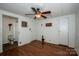Neutral bedroom with wood-look floors, ceiling fan, and two closets with white doors at 2144 Newhart Rd, Charlotte, NC 28214