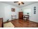 Bedroom with wood-look floors, dresser, and a writing desk with a lamp at 2144 Newhart Rd, Charlotte, NC 28214