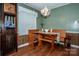 Bright dining nook featuring a wooden table and bench seating near the entry at 2144 Newhart Rd, Charlotte, NC 28214