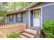 Inviting front entrance featuring brick steps, a picket fence, and freshly painted door at 2144 Newhart Rd, Charlotte, NC 28214