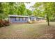 Exterior view of the home with a fenced front yard and established landscaping at 2144 Newhart Rd, Charlotte, NC 28214