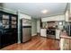 Spacious kitchen with wooden floors, modern appliances, and dark cabinetry at 2144 Newhart Rd, Charlotte, NC 28214