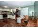 Inviting kitchen featuring a dining nook, wooden floors, and plentiful counter space at 2144 Newhart Rd, Charlotte, NC 28214
