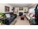 Relaxing living room with fireplace, a large TV, and comfortable seating arrangements at 2144 Newhart Rd, Charlotte, NC 28214