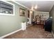 Inviting living room with carpet, shelving unit, accent art, and a view of laundry area at 2144 Newhart Rd, Charlotte, NC 28214