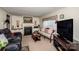 Comfortable living room with fireplace, large TV, and cozy seating, ideal for relaxation at 2144 Newhart Rd, Charlotte, NC 28214