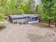 A scenic shot of the rear exterior, highlighting the home's siding, backyard and rear deck at 2144 Newhart Rd, Charlotte, NC 28214