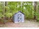Exterior showing small shed with metal door situated in wooded backyard at 2144 Newhart Rd, Charlotte, NC 28214
