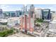 Stunning aerial view showcases the building within Charlotte's vibrant cityscape and parking areas at 222 S Caldwell St # 1510, Charlotte, NC 28202
