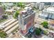 Expansive aerial view of a tall building in an urban environment with surrounding greenery at 222 S Caldwell St # 1510, Charlotte, NC 28202