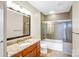 Bathroom boasts granite counters, modern fixtures, and a glass-enclosed tub-shower combo at 222 S Caldwell St # 1510, Charlotte, NC 28202