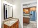 Bathroom features granite counters and view into the kitchen at 222 S Caldwell St # 1510, Charlotte, NC 28202