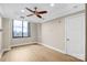Bright bedroom features a ceiling fan, recessed lighting, and large window with city views at 222 S Caldwell St # 1510, Charlotte, NC 28202