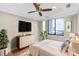 Cozy bedroom features wood floors, cityscape views, a ceiling fan, and a neutral color palette at 222 S Caldwell St # 1510, Charlotte, NC 28202