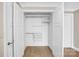 Walk-in closet with white wire shelving and wood flooring at 222 S Caldwell St # 1510, Charlotte, NC 28202