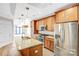 Stylish kitchen with stainless steel appliances, granite countertops, and center island with sink at 222 S Caldwell St # 1510, Charlotte, NC 28202