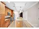 Contemporary kitchen with sleek appliances, a granite island, and warm wood cabinetry creating an inviting atmosphere at 222 S Caldwell St # 1510, Charlotte, NC 28202