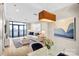 Open-concept living space with modern lighting, contemporary art, and floor-to-ceiling doors offering city views at 222 S Caldwell St # 1510, Charlotte, NC 28202
