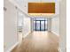 Bright living room features hardwood floors, neutral walls, balcony access, and a modern pendant light at 222 S Caldwell St # 1510, Charlotte, NC 28202