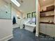 Bright bathroom with free-standing tub under skylight plus marble shower and custom shelving at 2309 Pinckney Ave, Charlotte, NC 28205