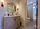 Modern bathroom featuring elegant wallpaper, stylish vanity, and a shower-tub combination with tasteful tile work at 2309 Pinckney Ave, Charlotte, NC 28205
