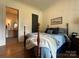 Comfortable bedroom featuring hardwood floors, ensuite bathroom and tranquil decor at 2309 Pinckney Ave, Charlotte, NC 28205