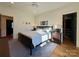 Bright bedroom with a ceiling fan, hardwood floors, a dark bed frame, and lots of natural light at 2309 Pinckney Ave, Charlotte, NC 28205