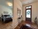 View of a bedroom with hardwood floors and natural light coming through the black frame windows at 2309 Pinckney Ave, Charlotte, NC 28205