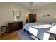 Bright bedroom featuring hardwood floors, a ceiling fan, a dark dresser, and access to a walk-in closet at 2309 Pinckney Ave, Charlotte, NC 28205