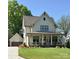 Charming two-story home with a inviting front porch, lush lawn and a detached garage in the back at 2309 Pinckney Ave, Charlotte, NC 28205
