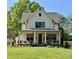 Charming two-story home with a inviting front porch, lush lawn and an entry door with glass pane at 2309 Pinckney Ave, Charlotte, NC 28205