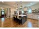 Bright, open kitchen boasts a central island, hardwood floors, and designer pendant lighting at 2309 Pinckney Ave, Charlotte, NC 28205