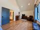 Bright living room featuring hardwood floors, vaulted ceilings, a leather chair, and traditional furnishings at 2309 Pinckney Ave, Charlotte, NC 28205