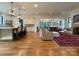 Bright and airy living room flowing into the open kitchen with hardwood floors and modern lighting at 2309 Pinckney Ave, Charlotte, NC 28205