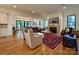 Inviting living room with a fireplace, comfortable seating, and large windows showcasing the natural light at 2309 Pinckney Ave, Charlotte, NC 28205