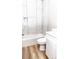 Bathroom showcasing stylish white marbled tile shower/tub, a modern vanity, and wood-look flooring at 2350 14Th Street Ne Ct, Hickory, NC 28601