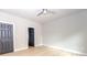 Neutral bedroom with a ceiling fan, light-colored walls and floors, and a gray door at 2350 14Th Street Ne Ct, Hickory, NC 28601