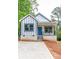 Charming new build home with a striking blue door, white siding, and black trim nestled in a leafy setting at 2350 14Th Street Ne Ct, Hickory, NC 28601