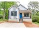 Charming new build home with a striking blue door, white siding, and black trim nestled in a leafy setting at 2350 14Th Street Ne Ct, Hickory, NC 28601
