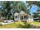 Beautiful home with a front porch, dark trim, manicured lawn and a modern white car in the driveway at 2350 14Th Street Ne Ct, Hickory, NC 28601