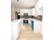 Modern kitchen featuring white cabinetry, black backsplash, stainless steel appliances, and quartz countertops at 2350 14Th Street Ne Ct, Hickory, NC 28601