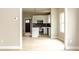 Modern kitchen featuring white cabinetry, black backsplash, stainless steel appliances, and light wood flooring at 2350 14Th Street Ne Ct, Hickory, NC 28601