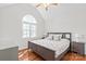 Bright bedroom featuring a large window, hardwood floors, and a cozy bed, creating a serene atmosphere at 255 Fernbrook Dr, Mooresville, NC 28117